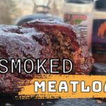 Sliced smoked meatloaf with a glaze and smoke ring